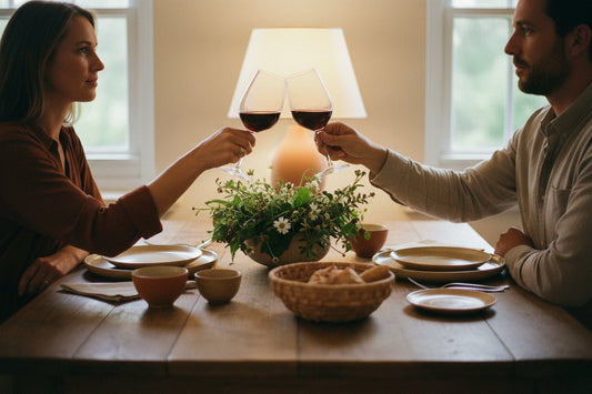 A couple toasting with wine at the dining table